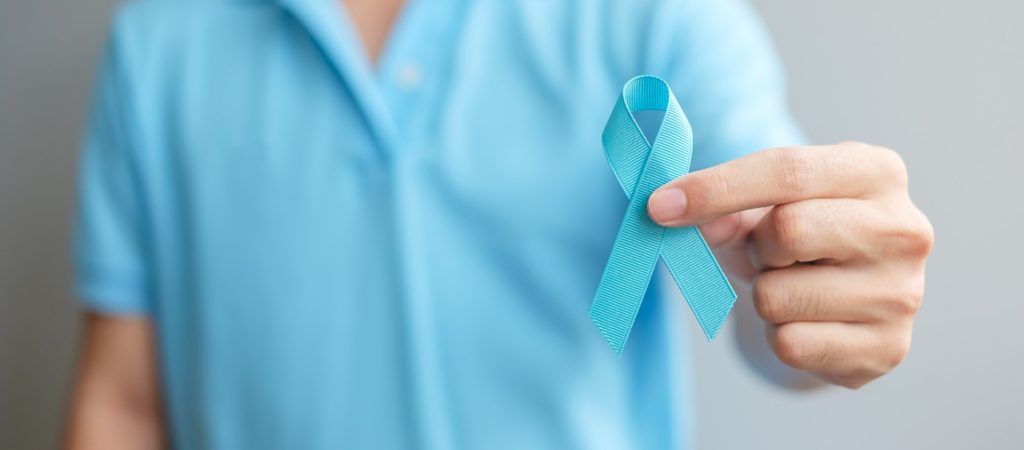 November Prostate Cancer Awareness, Man hand holding Blue Ribbon. men, Father and cancer day